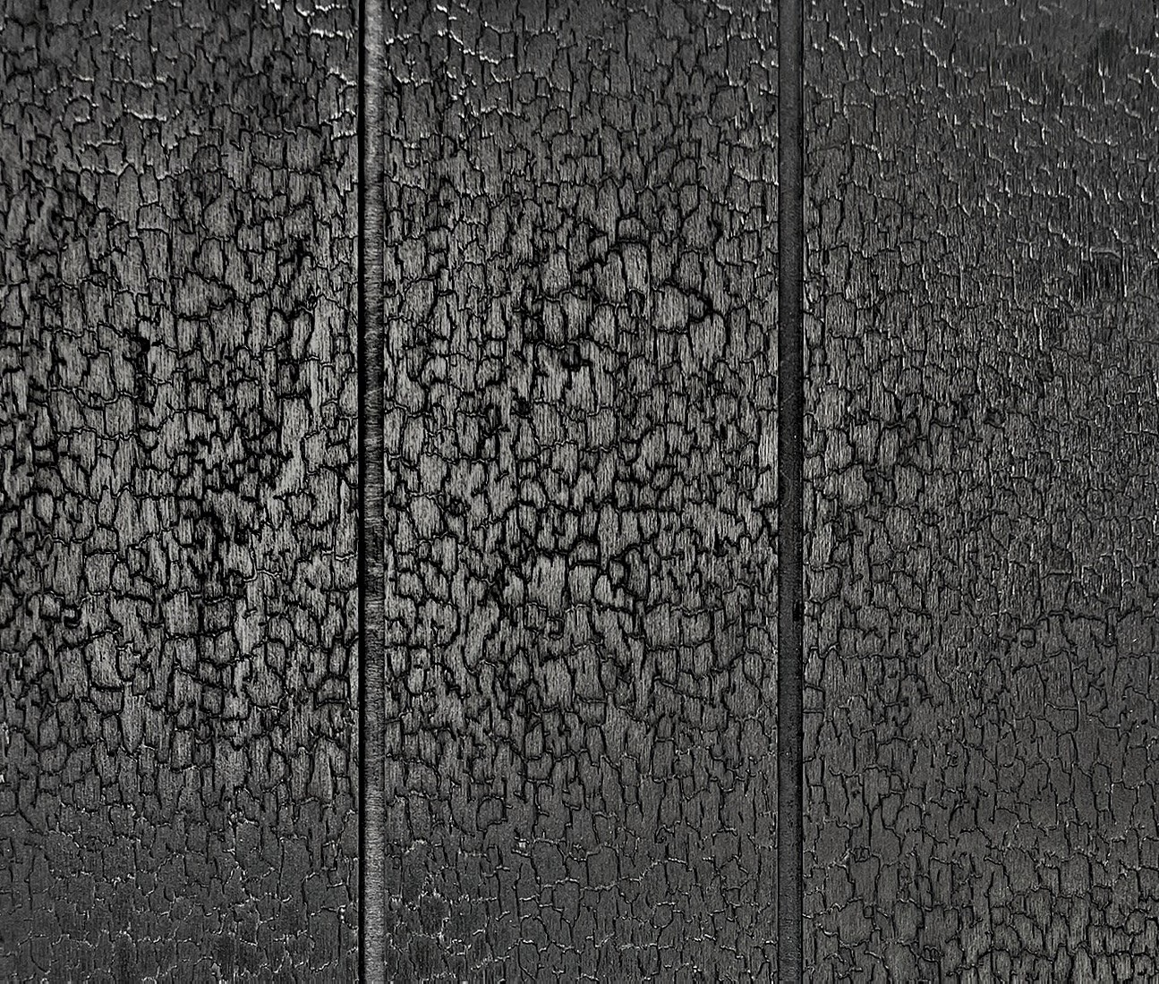 Close-up of the Scorched crackle texture across three shiplap boards, with the routed grooves between them